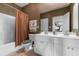 Bathroom with double sinks, white cabinetry, and shower with curtain and decorative towels at 9764 Leyland Dr. # 9764 - 5, Myrtle Beach, SC 29572