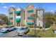 Condominium building featuring stone and siding with vibrant green awnings offering covered staircase and designated parking at 9764 Leyland Dr. # 9764 - 5, Myrtle Beach, SC 29572