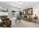 Bright, carpeted living room featuring a cozy fireplace and comfortable seating with lovely interior decor and finishes at 9764 Leyland Dr. # 9764 - 5, Myrtle Beach, SC 29572
