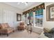 Bright sitting room with comfortable chairs, table, lamp and large windows providing ample natural light at 9764 Leyland Dr. # 9764 - 5, Myrtle Beach, SC 29572