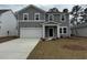 Charming two-story home with gray siding, a two-car garage, and a welcoming front porch at 997 Laconic Dr., Myrtle Beach, SC 29588
