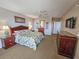 Bedroom features a queen bed with a floral comforter, wood furnishings, and a ceiling fan at 9994 Beach Club Dr. # 1904, Myrtle Beach, SC 29572