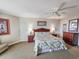 Comfortable bedroom with ceiling fan, a floral-patterned bedspread, and stylish wood furniture at 9994 Beach Club Dr. # 1904, Myrtle Beach, SC 29572