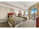 Comfortable bedroom with two beds, a ceiling fan, and a door leading to the balcony with ocean views at 9994 Beach Club Dr. # 1904, Myrtle Beach, SC 29572
