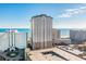 Expansive exterior shot of a beachfront high-rise condominium complex with stunning ocean views and ample parking at 9994 Beach Club Dr. # 1904, Myrtle Beach, SC 29572