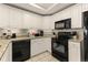 Kitchen featuring white cabinetry, granite countertops, and black appliances for a modern and clean look at 9994 Beach Club Dr. # 1904, Myrtle Beach, SC 29572