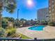 Beautiful outdoor pool featuring lush greenery and a view of the high-rise building at 9994 Beach Club Dr. # 1904, Myrtle Beach, SC 29572