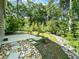 Scenic backyard with stone features and a concrete patio, perfect for outdoor living and entertaining at 1219 Inlet View Dr., North Myrtle Beach, SC 29582