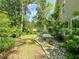 Landscaped backyard featuring a rock garden and lush green lawn surrounding a charming single-Gathering home at 1219 Inlet View Dr., North Myrtle Beach, SC 29582