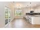 Bright dining area next to kitchen with stylish bar stools, pendant lights, and sliding glass door at 1219 Inlet View Dr., North Myrtle Beach, SC 29582