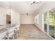 Elegant dining area with wood-look floors, a modern chandelier, and a sliding door to the outdoor space at 1219 Inlet View Dr., North Myrtle Beach, SC 29582