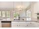 Bright kitchen featuring a granite island with a stainless steel sink and modern pendant lighting at 1219 Inlet View Dr., North Myrtle Beach, SC 29582