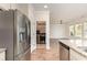 Modern kitchen with stainless steel appliances, granite counters, and a view into the laundry room at 1219 Inlet View Dr., North Myrtle Beach, SC 29582