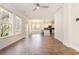 Open-concept living room with hardwood floors, large windows, and ceiling fan at 1219 Inlet View Dr., North Myrtle Beach, SC 29582