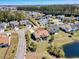An aerial view of a neighborhood featuring well-maintained homes, green spaces, and community ponds at 324 Highfield Loop, Myrtle Beach, SC 29579