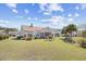 Spacious backyard featuring a hot tub, fire pit, and screened-in porch at 324 Highfield Loop, Myrtle Beach, SC 29579