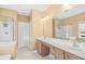 A bright bathroom with double sinks, a large mirror and glass-enclosed shower at 324 Highfield Loop, Myrtle Beach, SC 29579