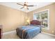 Cozy bedroom with neutral walls and a view of the yard and lake from the window at 324 Highfield Loop, Myrtle Beach, SC 29579