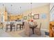 An open dining area with wood table, upholstered chairs and view of the kitchen at 324 Highfield Loop, Myrtle Beach, SC 29579