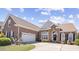 Beautiful brick home with a manicured lawn, a two-car garage, and an arched front entrance at 324 Highfield Loop, Myrtle Beach, SC 29579