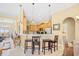 Open kitchen with wood cabinets, stainless steel appliances, and a breakfast bar with stools at 324 Highfield Loop, Myrtle Beach, SC 29579