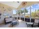 Relaxing screened patio featuring wicker furniture and views of the lake at 324 Highfield Loop, Myrtle Beach, SC 29579