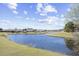 Scenic view of the pond surrounded by lush greenery and mature trees at 324 Highfield Loop, Myrtle Beach, SC 29579