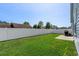 Large backyard with green lawn, white fence, and mature trees at 361 Rycola Circle, Myrtle Beach, SC 29575