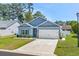 Charming single-story home with a two-car garage, blue siding, manicured lawn, and tasteful landscaping at 361 Rycola Circle, Myrtle Beach, SC 29575