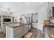 Modern kitchen featuring stainless steel appliances, gray cabinets, and granite countertops, flowing into the living room at 361 Rycola Circle, Myrtle Beach, SC 29575