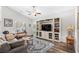 Bright living room featuring a large entertainment center, ceiling fan, and cozy furniture on a beautiful area rug at 361 Rycola Circle, Myrtle Beach, SC 29575