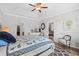 Bright main bedroom with a ceiling fan, tray ceiling, and en-suite bathroom at 361 Rycola Circle, Myrtle Beach, SC 29575