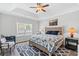 Serene main bedroom with tray ceiling, a ceiling fan, and large window allowing for natural light at 361 Rycola Circle, Myrtle Beach, SC 29575