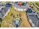 Aerial view showcasing a condo building, meticulously landscaped grounds, and a heart-shaped pool with lounge chairs at 4827 Orchid Way # 301, Myrtle Beach, SC 29577