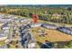 Wide aerial perspective of the community showcasing a pool, lush golf course, nearby residences, and tranquil waterway features at 4827 Orchid Way # 301, Myrtle Beach, SC 29577