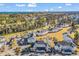 Sweeping aerial view capturing residences, lush landscapes, a pool area, golf course, and distant views of the ocean at 4827 Orchid Way # 301, Myrtle Beach, SC 29577
