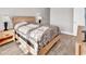 Cozy bedroom featuring two lamps, a nightstand, light-colored furniture, and hardwood floors at 4827 Orchid Way # 301, Myrtle Beach, SC 29577