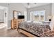Bright bedroom with a vaulted ceiling, ceiling fan, dresser with TV, and an outside view at 4827 Orchid Way # 301, Myrtle Beach, SC 29577