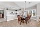 A dining area with wooden table and chairs, open to the kitchen, with natural light from the windows at 4827 Orchid Way # 301, Myrtle Beach, SC 29577