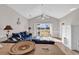 Bright living room with a couch and open sliding glass doors to a view of nature at 4827 Orchid Way # 301, Myrtle Beach, SC 29577