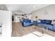 Open-concept living area with blue sofas, vaulted ceiling, and seamless flow to the kitchen and dining spaces at 4827 Orchid Way # 301, Myrtle Beach, SC 29577