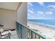 Balcony overlooking beach and ocean, with seating to enjoy the coastal view at 501 S Ocean Blvd. # 1002, North Myrtle Beach, SC 29582