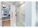 Modern bathroom featuring a glass enclosed shower with accessibility handrails and view to bedroom at 501 S Ocean Blvd. # 1002, North Myrtle Beach, SC 29582