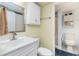Well lit bathroom with cabinet space, shower, toilet, vanity with mirror and adjacent toilet at 501 S Ocean Blvd. # 1002, North Myrtle Beach, SC 29582
