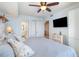 Bedroom with queen bed, ceiling fan, TV, and views into the bathroom and hallway at 501 S Ocean Blvd. # 1002, North Myrtle Beach, SC 29582