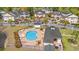 Aerial view of community pool, clubhouse, and pond surrounded by multiple condominium buildings at 5022 Belleglen Ct. # 202, Myrtle Beach, SC 29579