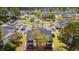 An aerial view showcasing the community buildings, pool, and surrounding landscape with trees and a pond at 5022 Belleglen Ct. # 202, Myrtle Beach, SC 29579