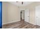 Bedroom featuring wood-look flooring, a ceiling fan, and access to an ensuite bathroom at 5022 Belleglen Ct. # 202, Myrtle Beach, SC 29579