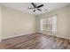 Bright bedroom featuring wood-look flooring, a ceiling fan, and a large window at 5022 Belleglen Ct. # 202, Myrtle Beach, SC 29579
