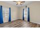 Bedroom featuring wood-look flooring, a ceiling fan, and bright blue curtains at 5022 Belleglen Ct. # 202, Myrtle Beach, SC 29579